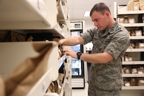 U.S. Air Force Capt. David Lang, 359th Medical Operations Squadron officer in charge of clinic pharmacy, searches for a prescription in the Exchange pharmacy Feb. 12, 2013, at Joint Base San Antonio-Randolph. (U.S. Air Force photo by Joshua Rodriguez/ Released)