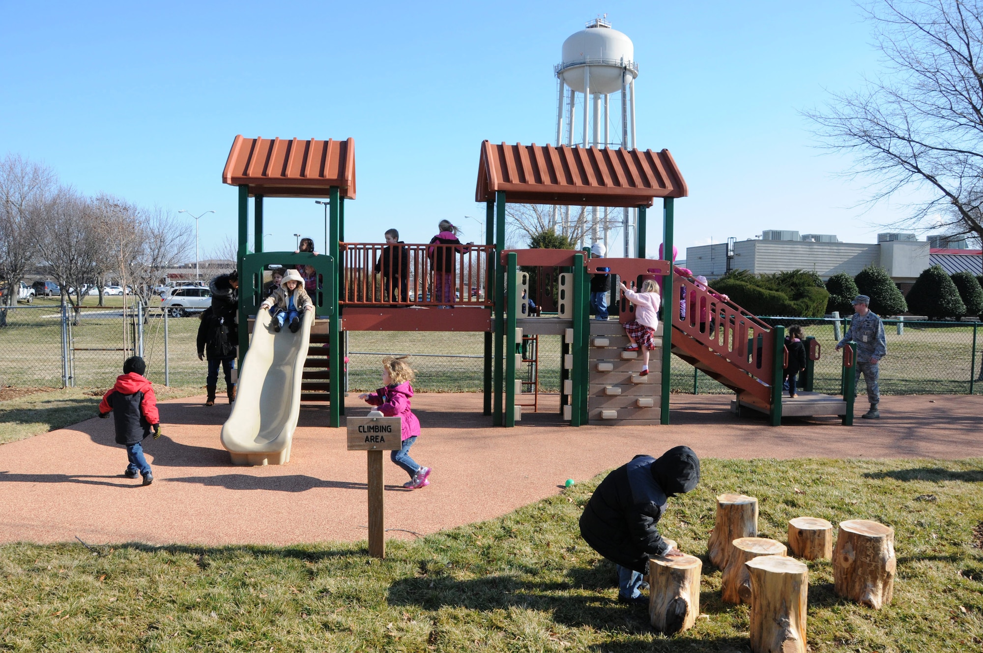 Preschool-aged children, enrolled at the Dover Air Force Base, Del., Child Development Center, try out new and improved playground equipment following a ribbon cutting ceremony Feb. 15, 2013. The ceremony symbolized the end of a six-month Army Corps of Engineers project to upgrade and replace playground equipment and play areas, which were showing signs of wear and tear. (U.S. Air Force photo/Master Sgt. Veronica Aceveda)