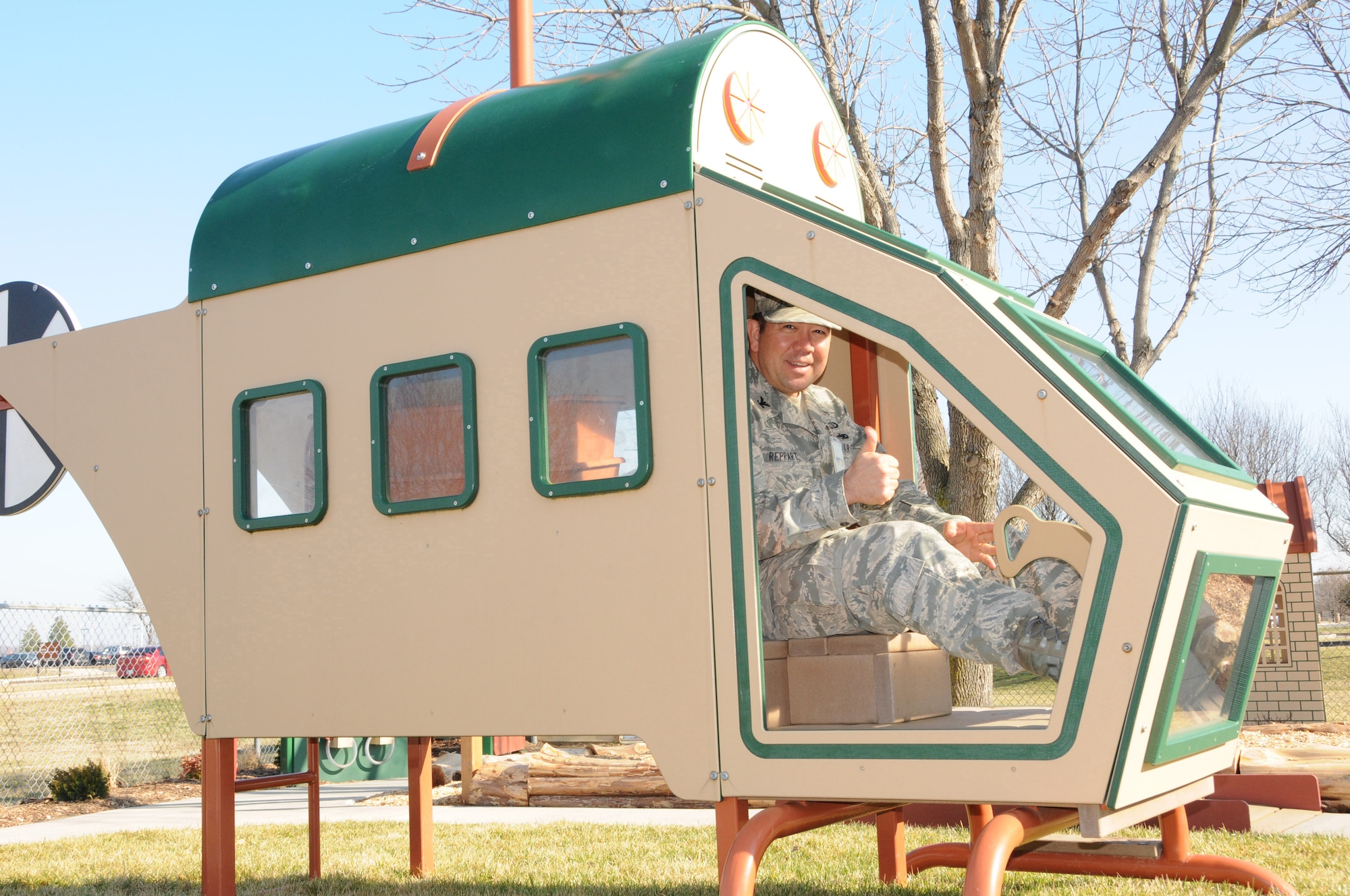 Col. Thomas A. Reppart, 436th Mission Support Group commander, takes a toy static helicopter for a test drive Feb. 15, 2013, before the ribbon cutting ceremony of the Child Development Center's new and improved playground on Dover Air Force Base, Del. Lt. Col. Matthew Orlowsky, 512th Force Support Squadron commander, accompanied Reppart for the ceremony on the playground, which is designed for use by the preschool age children at the center. (U.S. Air Force photo/Master Sgt. Veronica Aceveda)