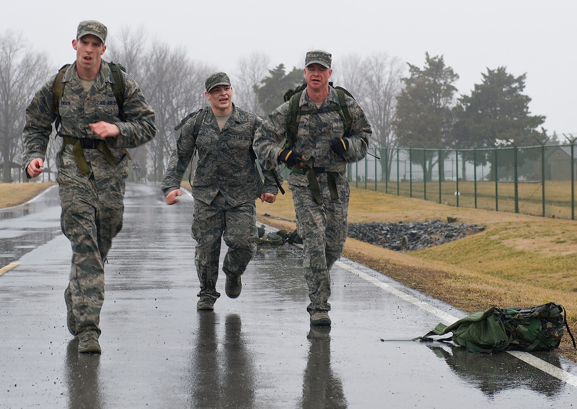 Senior Airman Ethan Jensen, left, Senior Airman Marcus Lopez and Master Sgt. Paul Schuster, members of the 436th Aerial Port Squadron, complete the 6.2-mile 14th Annual Korean War Ruck March Feb. 23, 2013, at Dover Air Force Base, Del. The four-man team, which also included Staff Sgt. Dustin Trevino, took first place with a time of 1 hour, 6 minutes and 15 seconds. (U.S. Air Force photo by Senior Airman Sam Taylor)  
