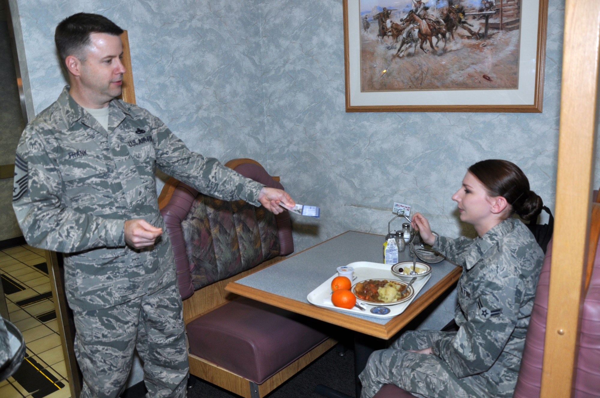 GOODFELLOW AIR FORCE BASE, Texas –Chief Master Sgt. Robert Frank, Air Force first sergeant special duty manager, gives Airman 1st Class Laura Gripp, 316th Training Squadron student, a $10 Army and Air Force Exchange Service gift card at the Western Winds Dining Facility here, Feb. 19. Frank, along with the First Sergeants’ Council, handed out a total of 50 gift cards. (U.S. Air Force photo/ Airman 1st Class Joshua Edwards)