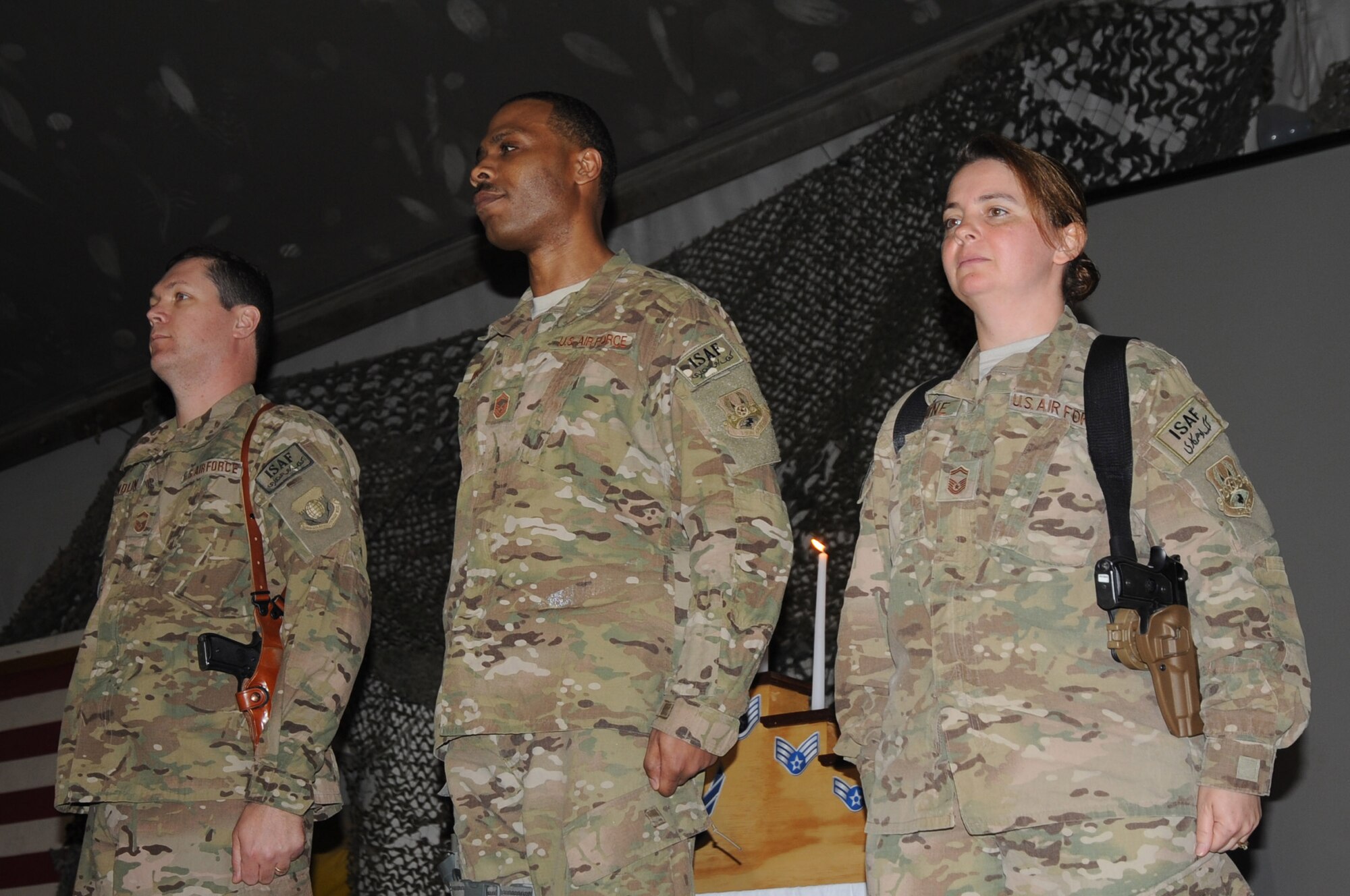 (From left to right) Senior Master Sgts. Shane Sandlin, Sydney Parker and Wendy Ragnone stand at attention during their induction ceremony on Bagram Airfield, Afghanistan, Feb. 24, 2013. Each has been selected for promotion to the rank of chief master sergeant. (U.S. Air Force photo/Staff Sgt. David Dobrydney)