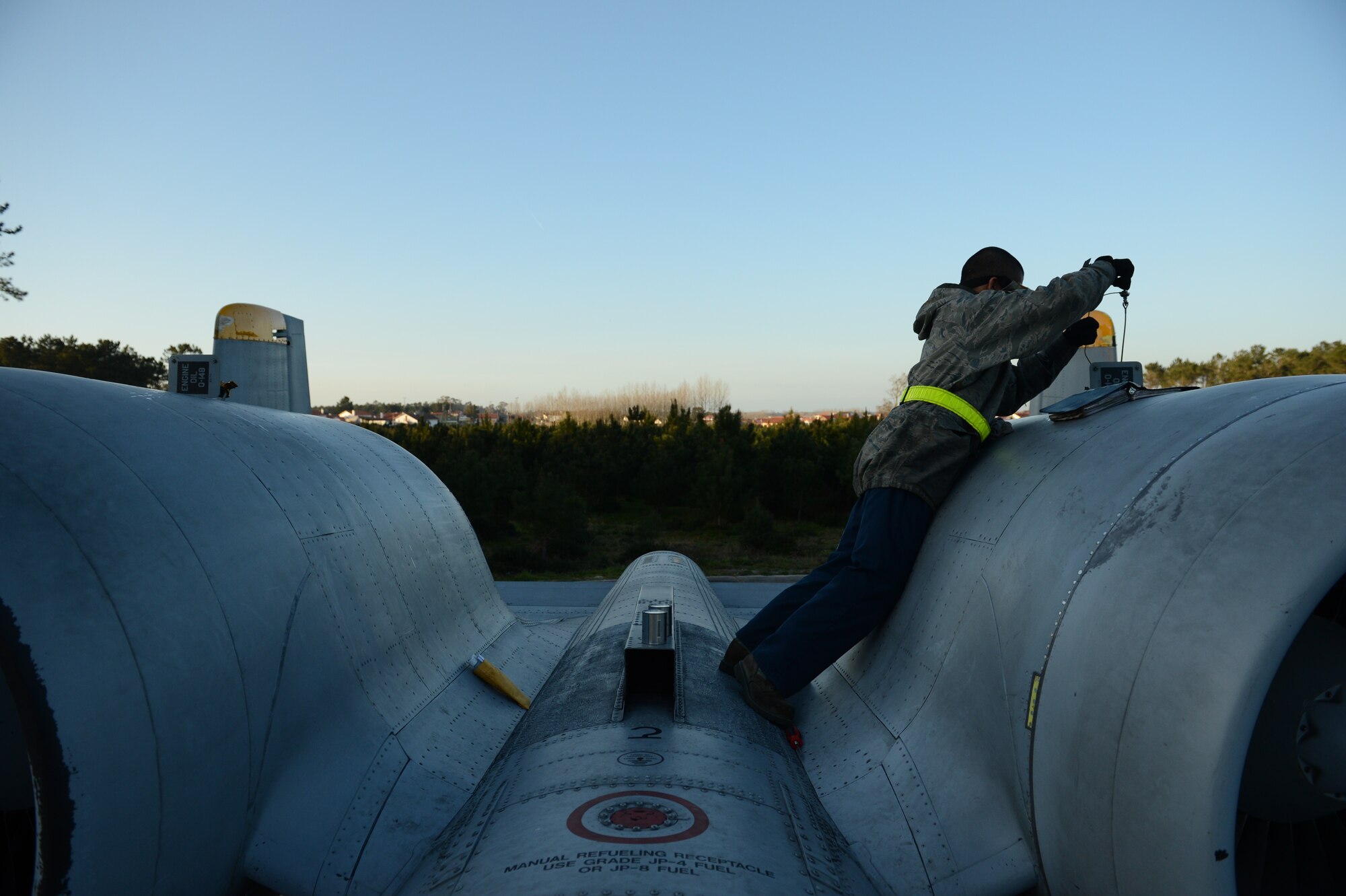 MONTE REAL, Portugal – U.S. Air Force Airman 1st Class Fernando Sorto, 81st Aircraft Maintenance Unit crew chief from Plano, Texas, checks the oil on an A-10 Thunderbolt II engine in Monte Real, Portugal, Feb. 14, 2013. REAL THAW uses simulated scenarios with complex, realistic situations to provide appropriate training for multinational, joint theater operations. (U.S. Air Force photo by Staff Sgt. Nathanael Callon/Released)