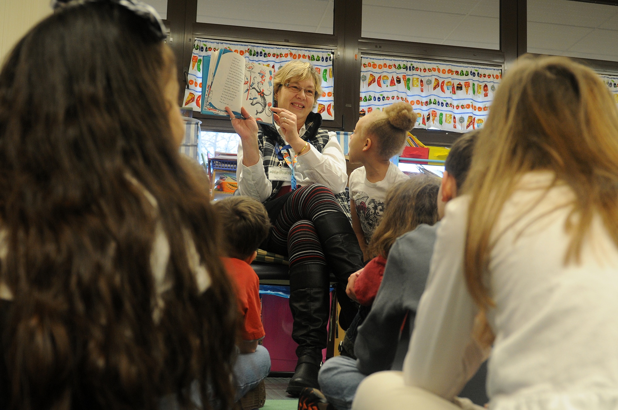 Students of Marianne Warwick’s first-grade class listen, as she reads “The Cat in the Hat” as part of Read Across America week at Ramstein Elementary School on Ramstein Air Base, Germany, Feb. 25, 2012. Entering its 16th year, Read Across America is a national event, also held at overseas military installations, to educate children of all ages about the importance of reading.(U.S. Air Force photo/Airman 1st Class Holly Cook)