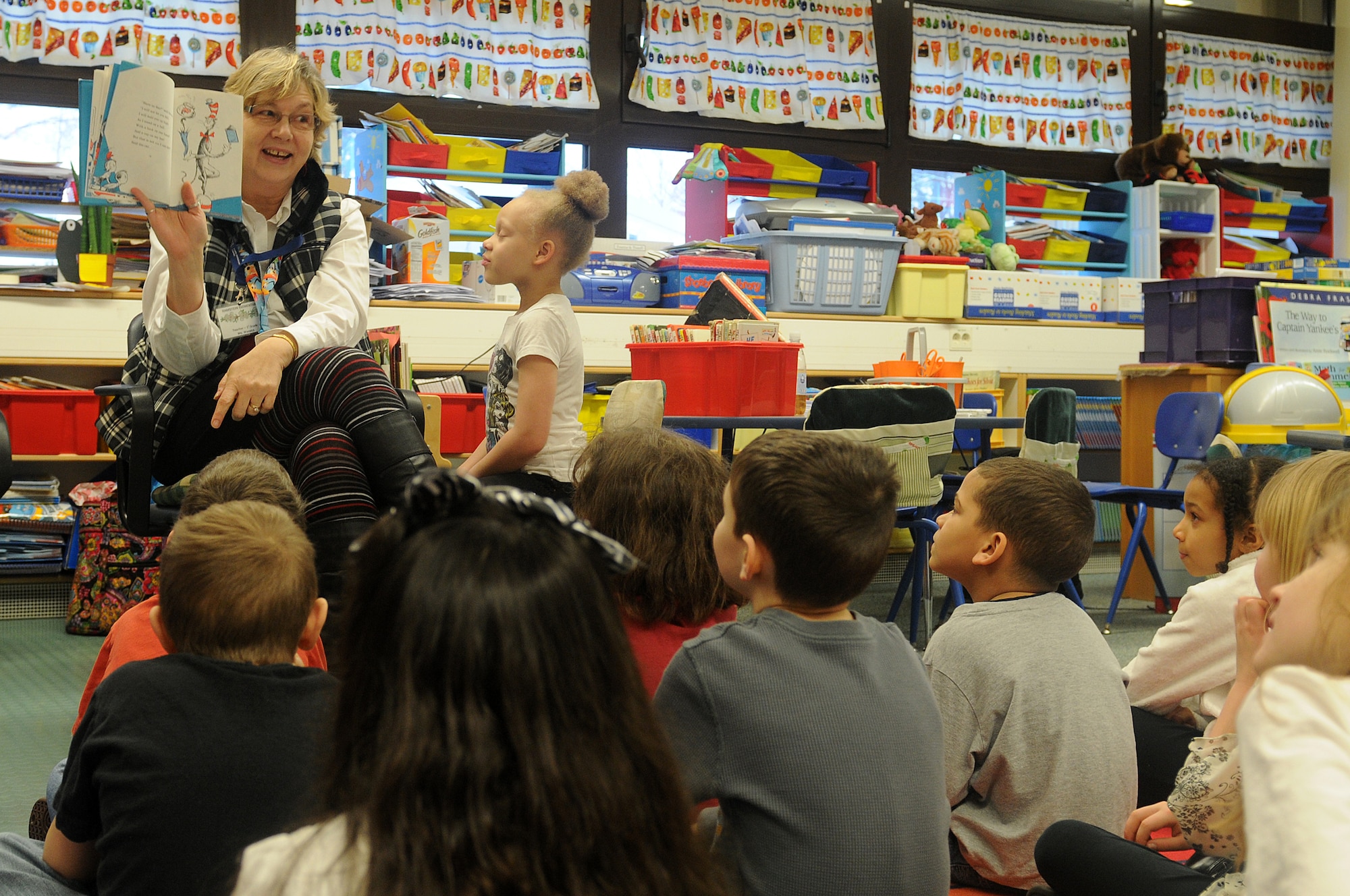 Students of Marianne Warwick’s first-grade class listen, as she reads “The Cat in the Hat” as part of Read Across America week at Ramstein Elementary School on Ramstein Air Base, Germany, Feb. 25, 2012. Entering its 16th year, Read Across America is a national event, also held at overseas military installations, to educate children of all ages about the importance of reading.(U.S. Air Force photo/Airman 1st Class Holly Cook)
