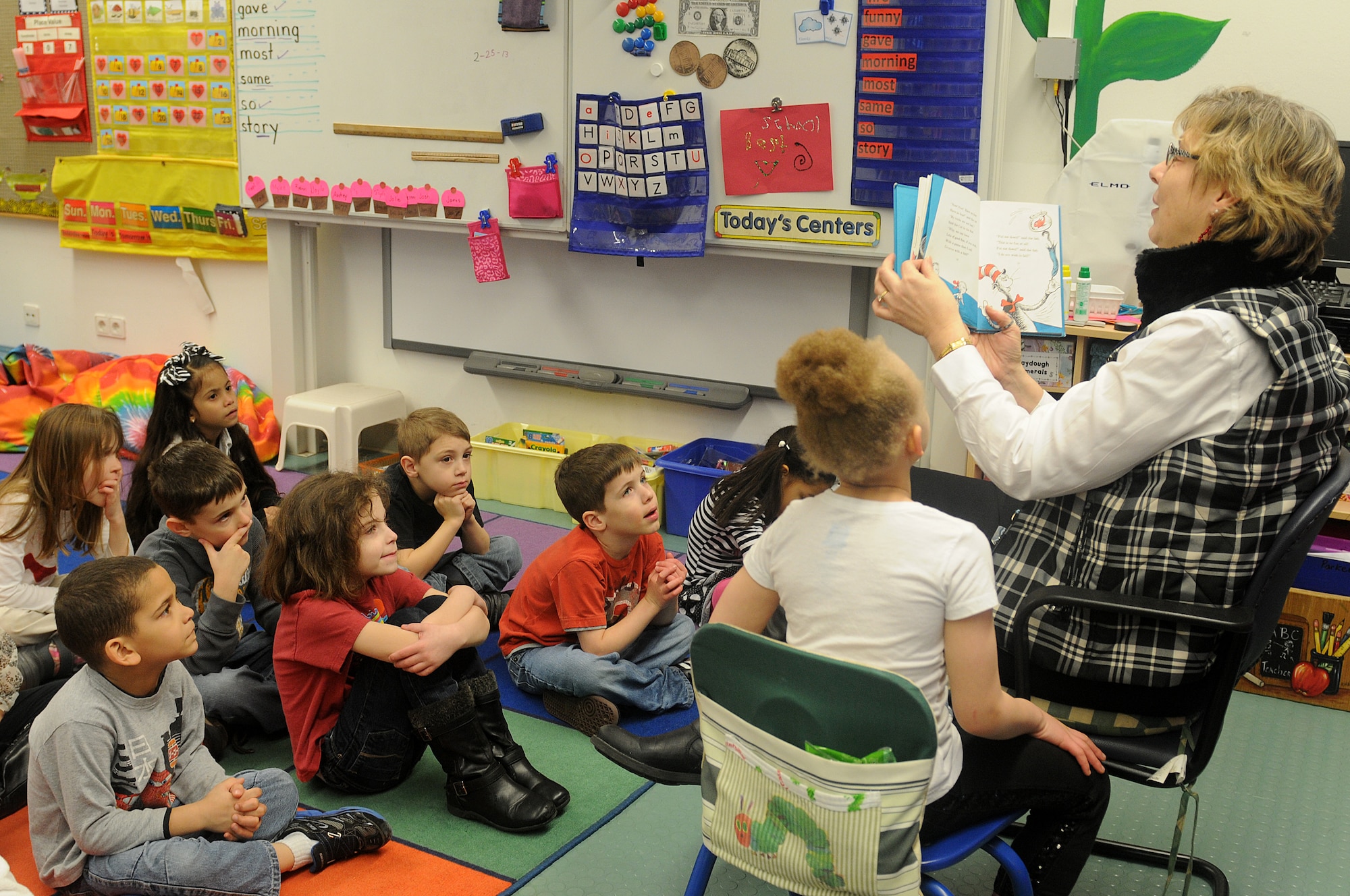 Students of Marianne Warwick’s first-grade class listen, as she reads “The Cat in the Hat” as part of Read Across America week at Ramstein Elementary School on Ramstein Air Base, Germany, Feb. 25, 2012. Entering its 16th year, Read Across America is a national event, also held at overseas military installations, to educate children of all ages about the importance of reading.(U.S. Air Force photo/Airman 1st Class Holly Cook)