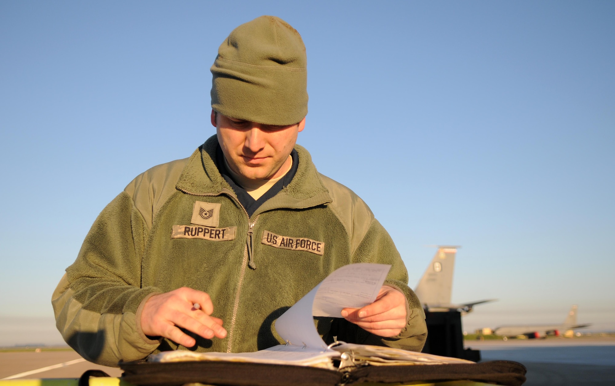 Tech. Sgt. Michael Ruppert, a 100th Aircraft Maintenance Squadron aerospace propulsion craftsman from Fort Meyers, Fla., examines paperwork on one of the KC-135 Stratotankers he helps maintain Feb. 25, 2013. Ruppert deployed to southwest Europe in January from RAF Mildenhall, England, in support of French operations in Mali. (U.S. Air Force photo by Staff. Sgt. Austin M. May)