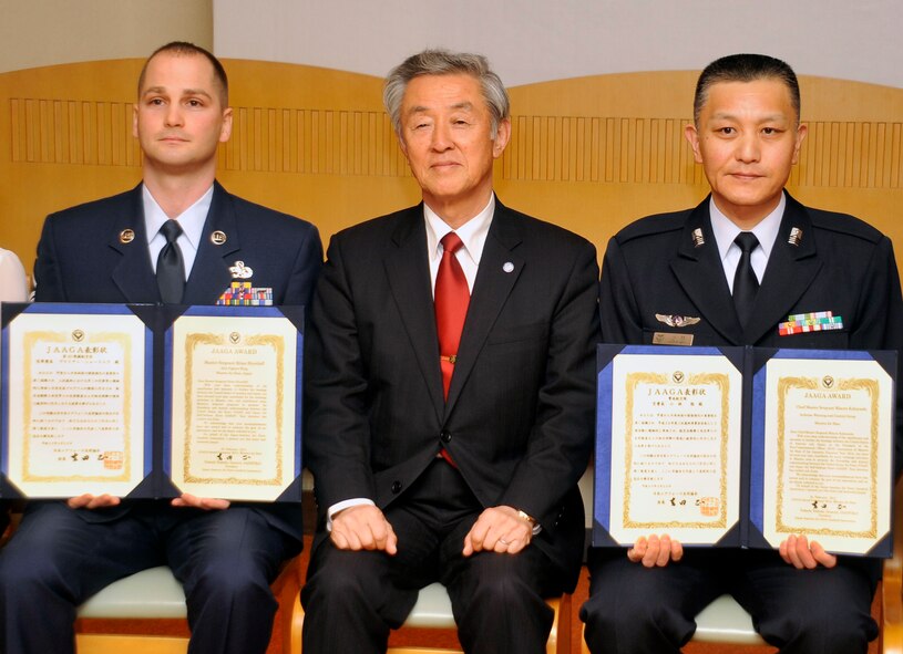 U.S. Air Force Master Sgt. Brian Shurtleff, left, 35th Maintenance Squadron weapons maintenance NCO in charge, retired Japan Air Self-Defense Force Lt. Gen. Seiji Kagawa, middle, Japan-America Air Force Goodwill Association vice president, and JASDF Chief Master Sgt. Minoru Kobayashi pose for a group photo at the end of the JAAGA Awards Ceremony at Misawa Air Base, Japan, Feb. 22, 2013. Shurtleff and Kobayashi received awards from the JAAGA for their outstanding bilateral work in Calendar Year 2012. (U.S. Air Force photo by Airman 1st Class Zachary Kee)