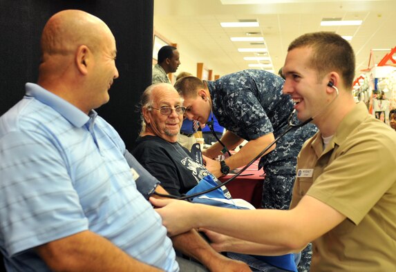 U.S. Navy Seaman Zachary Midcalf and Petty Officer 3rd Class Michael Matthews, U.S. Naval Hospital Okinawa preventive medicine technicians, provide blood pressure checks at the Exchange during a Joint Health Promotion Fair on Kadena Air Base, Japan, Feb. 21, 2013. The fair included displays on high blood pressure education, sickle-cell disease awareness and diabetes awareness. There were also laboratory service representatives who shared vital information with base residents from across the island. (U.S. Air Force photo/Naoto Anazawa)


