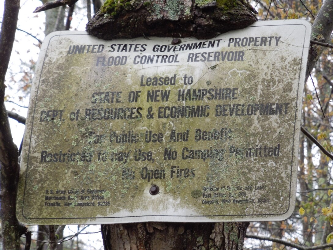 A sign notifies visitors at Blackwater Dam, Webster, N.H., that the land leased by the state is for the public's use and benefit. Blackwater Dam was completed in 1941 at a cost of $1.32 million and has already prevented $15.3 million in damages. The reservoir has a storage capacity of 15 billion gallons of water. The Blackwater Dam offers visitors approximately 3,600 acres of land and water for recreational opportunities. The pristine environment includes a meandering eight-mile stretch of the Blackwater River, an excellent place to canoe and kayak, stocked with brown and rainbow trout. (U.S. Army Corps of Engineers photo)