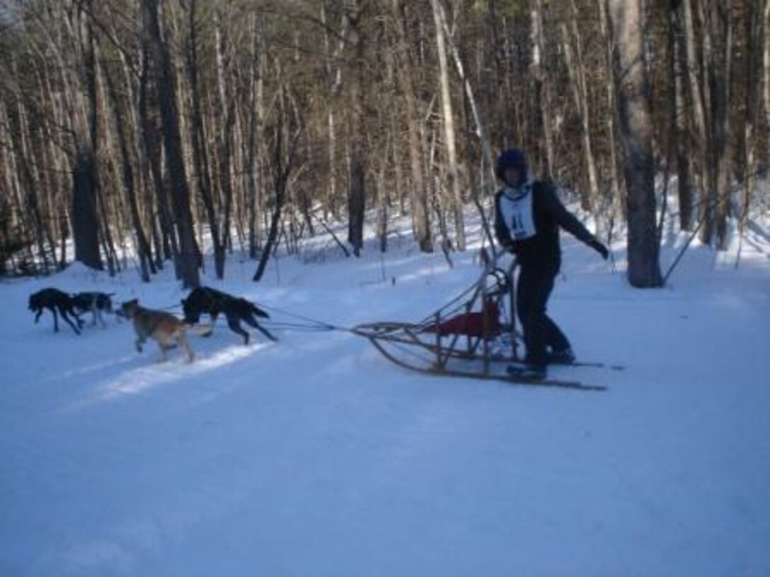 A participant in a sled dog race flies through Franklin Falls Dam reservoir, Franklin, N.H.