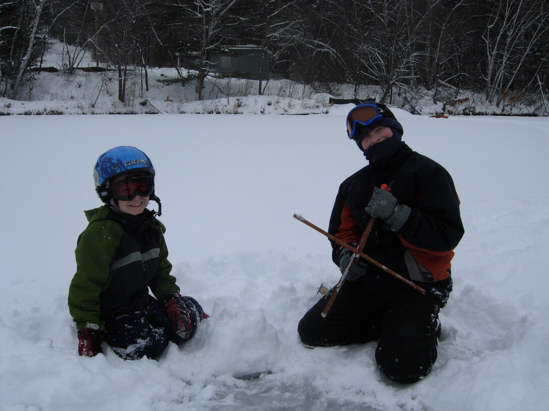 A couple of children ice fish at Franklin Falls Dam during a winter Ranger program, Franklin, N.H.