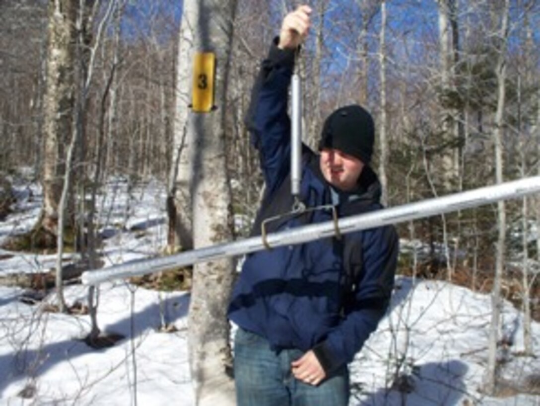 A volunteer takes snow measurements for snow survey at Franklin Falls Dam, Franklin, N.H. Franklin Falls Dam was built and constructed in 1943 on the Pemigewasset River to protect cities and towns along the Merrimack from flood damage. Since it's conception in 1943, the dam has prevented over $165 million in damages. Also, by using flood control land, we are able to create and manage recreational opportunities for every age. Many people enjoy hunting, fishing, hiking, biking, kayaking and snowshoeing. (U.S. Army Corps of Engineers photo)