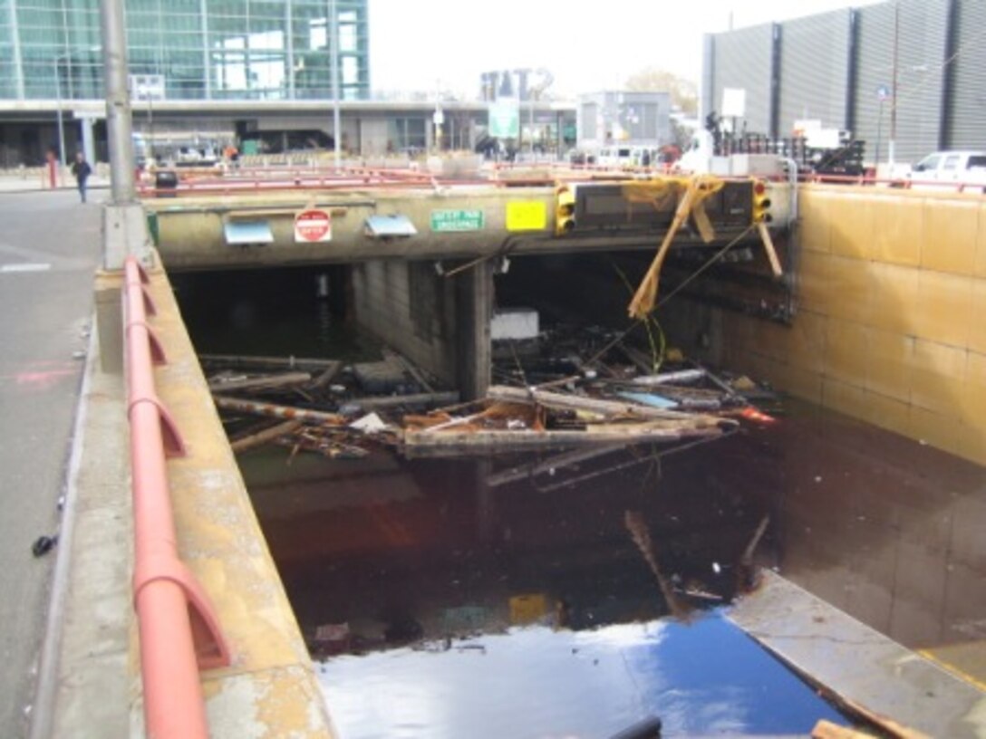 Debris floats in the tunnel opening of New York City’s Battery Park Underpass following Hurricane Sandy in October. This photo was taken after the unwatering team had lowered the water by about 10 feet.