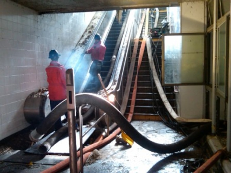 Hoses and other necessary equipment were lugged up and down escalators to aide in the unwatering mission.