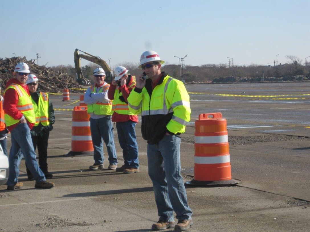 Jeff McCrery discusses safety issues at a debris site following Hurricane Sandy this fall. The team of safety specialists were there to ensure Corps employees and the contractor were in full compliance with all safety regulations.