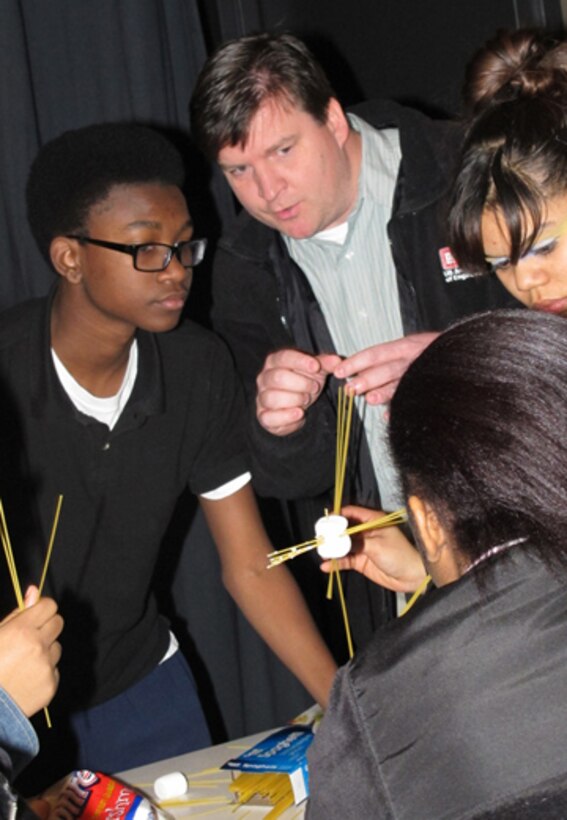 Huntsville Center Engineer Jason Page, advises his student team during a National Engineers Week activity at J.O. Johnson High School, Feb. 21.