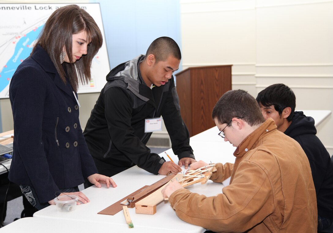 High school students from a dozen Portland-area schools visited Bonneville Lock and Dam Feb. 21 to celebrate Engineer Day. Students learn about structural engineering during a bridge-building exercise.