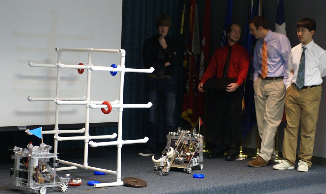 Team members from the Owasso Robotics program demonstrate their robot during the SAME meeting at the Tulsa District.