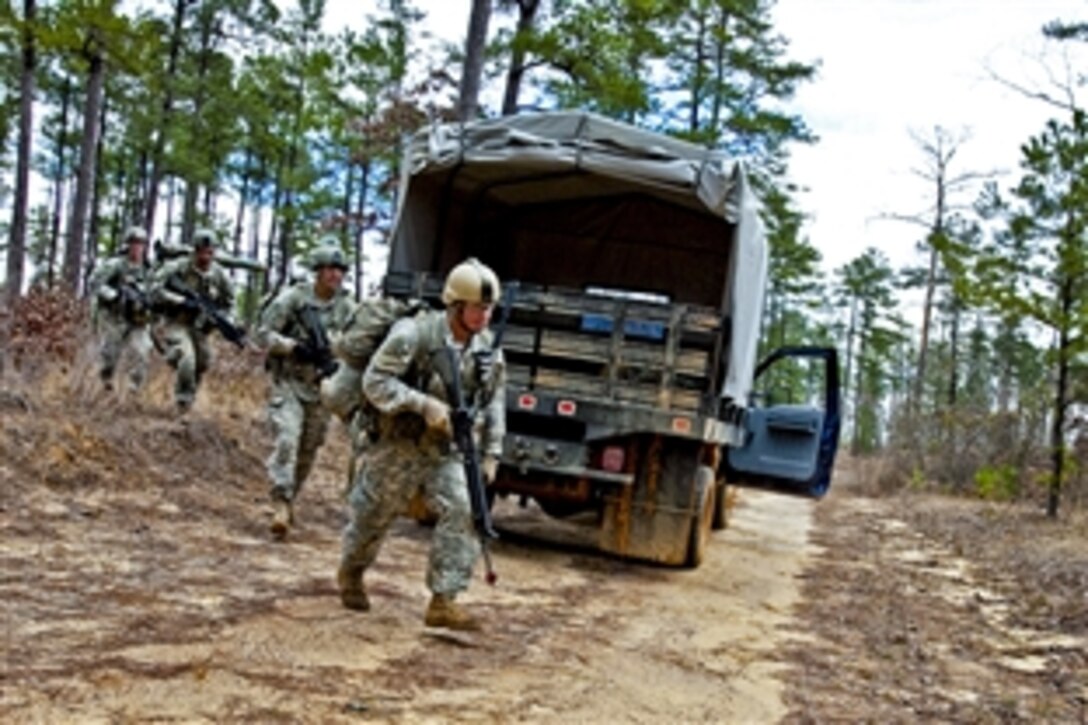 Soldiers move across a road during the final exercise of a Ranger assessment course at the Army National Guard Warrior Training Center on Fort Benning, Ga., Feb. 19, 2013. 