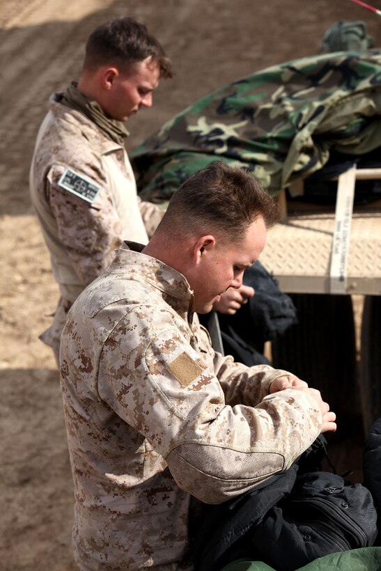 U.S. Marines Cpl. Justin Abbott, mortar man, below, and Lance Cpl. Devlin Linhardt, motor transportation operator with Combat Logistics Regiment 2 (CLR-2), hang their sleeping systems to dry during Operation Dynamic Partner in Helmand province, Afghanistan, Feb. 13, 2013. CLR-2 provided tactical logistics support to Regimental Combat Team 7 (RCT-7) in order to extract equipment from VSP Shurakay to facilitate its demilitarization. (U.S. Marine Corps photo by Sgt. Anthony L. Ortiz / Released)