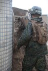 A combat engineer with Engineer Company, Combat Logistics Battalion 6, 2nd Marine Logistics Group tears open one of the many barriers used to fortify the company’s training patrol base aboard Camp Lejeune, N.C., Feb. 26, 2013. The Marines piled thousands of pounds of dirt to build the walls of the base, which was used during the unit’s pre-deployment training.  
