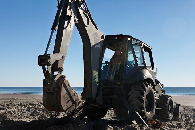 Lance Cpl. Avery Reddish, Marine Wing Support Squadron 273 heavy equipment operator, uses a backhoe loader during an Engineer Company Community Relations Project on Hunting Island State Park, Feb. 20. Hunting Island is currently the fastest eroding beaches on the East Coast losing approximately 15 feet of sand each year. 