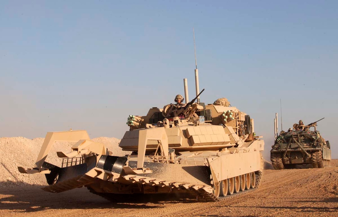 A U.S. Marine Corps M1 Assault Breacher Vehicle followed by an M88A2 Hercules Recovery Vehicle, both assigned to Mobile Assault Company, 2nd Combat Engineer Battalion, enter the main staging area for units supporting Operation Dynamic Partnership in Shurakay, Helmand province, Afghanistan, Feb. 9, 2013. Dynamic Partnership was a multi-unit operation to retrograde all U.S. military equipment and personnel from Shurakay district. (U.S. Marine Corps photo by Cpl. Alejandro Pena/Released)