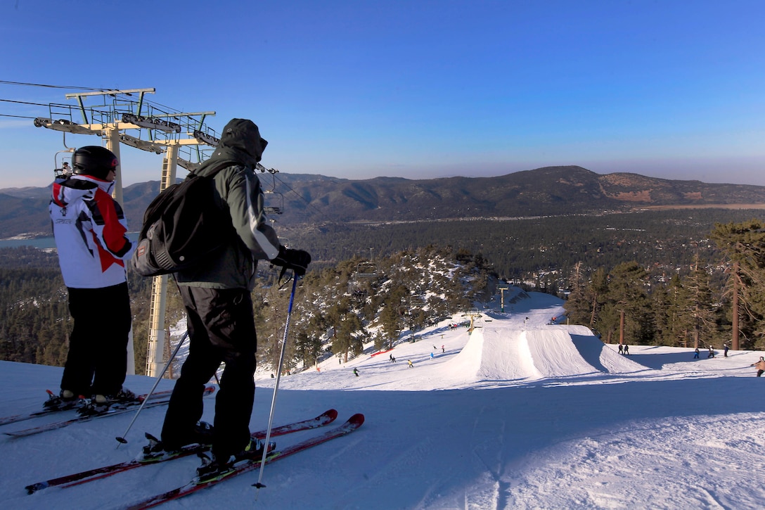 Skiers overlook Big Bear Lake before attempting a 15-foot jump on the Bear Mountain Express trail. Marines equipped with a snowboard or skis hit the slopes of Bear Mountain Resort during a Single Marine Program snow trip Feb. 23.
