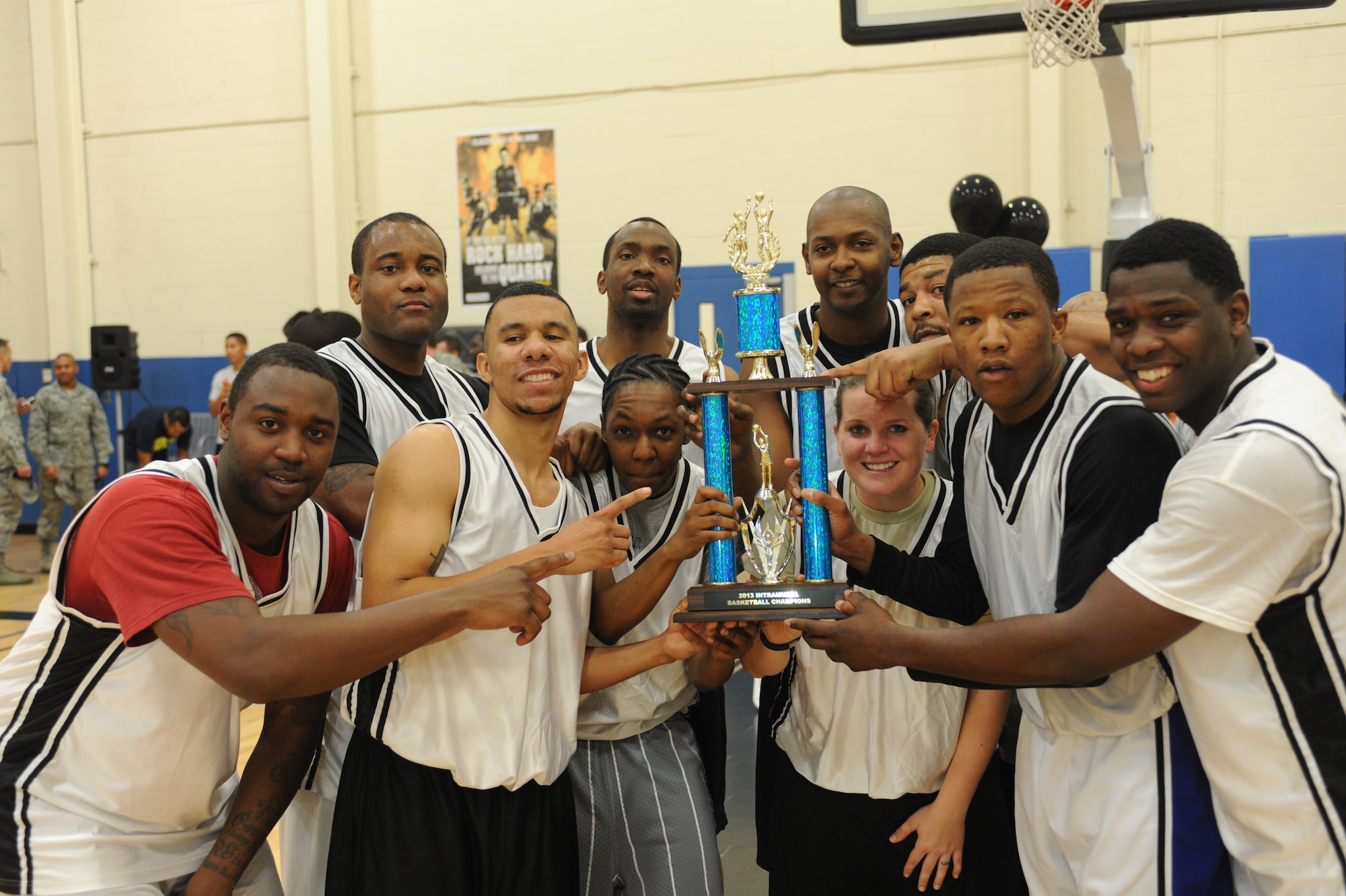 Members of 9th Aircraft Maintenance Squadron celebrate during the trophy presentation during the Intramural Basketball Championship at the Harris Fitness Center on Beale Air Force Base, Calif., Feb. 22, 2013. The 9th AMXS defeated the 48th Intelligence Squadron 37-34. (U.S. Air Force photo by Airman 1st Class Bobby Cummings/Released)