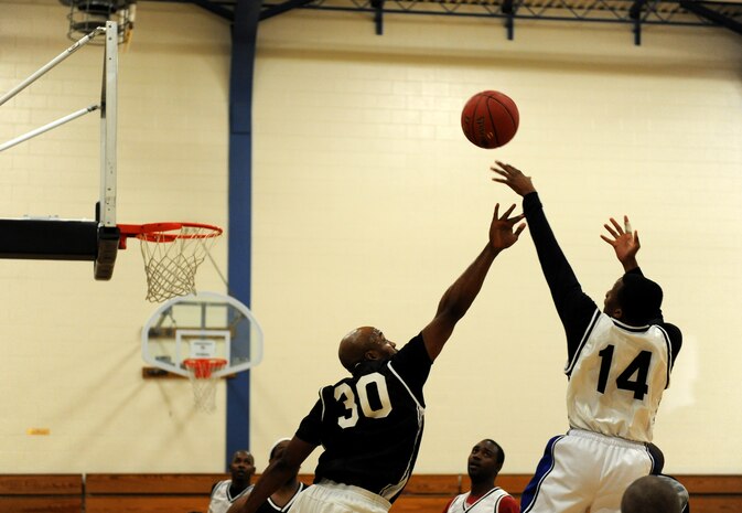 Senior Airman Alton White Jr., 9th Aircraft Maintenance Squadron shooting guard, attempts a shot during the Intramural Basketball Championship at the Harris Fitness Center on Beale Air Force Base, Calif., Feb. 22, 2013. The 9th AMXS defeated the 48th Intelligence Squadron 37-34. (U.S. Air Force photo by Staff Sgt. Robert M. Trujillo/Released)