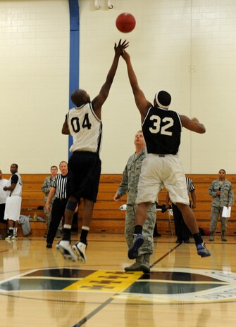 Col. Jason Green, 9th Mission Support Group commander conducts the ceremonial tip-off during the Intramural Basketball Championship at the Harris Fitness Center on Beale Air Force Base, Calif., Feb. 22, 2013. The 9th Aircraft Maintenance Squadron defeated the 48th Intelligence Squadron 37-34. (U.S. Air Force photo by Staff Sgt. Robert M. Trujillo/Released)