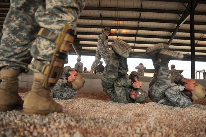 Airmen assigned to 820th Red Horse squadron from Nellis Air Force Base, Nev., practice parachute landing falls under the watchful eye of a jumpmaster prior to an airborne operation, Feb. 23. The 820th engineers traveled to Fort Bragg, N.C., to conduct airfield maintenance training with 161st Engineer Company, 27th Engineer Battalion, 20th Engineer Brigade. Both units will be augmenting 2nd Brigade Combat Team, 82nd Airborne Division for the Joint Operational Access Exercise, Feb. 27 - March 9, as well as supporting 2BCTs Global Response Force mission. (U.S. Army photo by Sgt. Kissta DiGregorio)