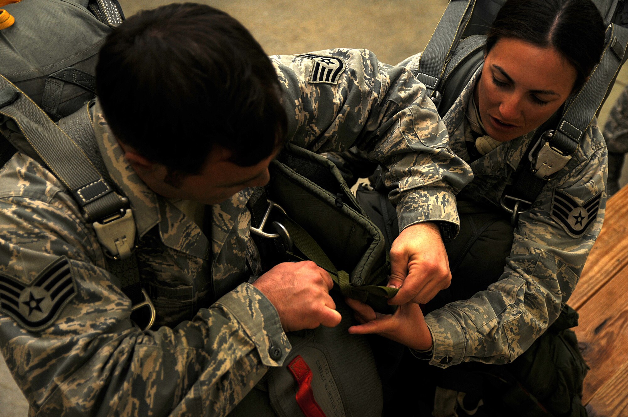 Air Force paratroopers help each other don their equipment prior to an airborne operation, Feb. 23. Airmen assigned to 820th RED HORSE Squadron from Nellis Air Force Base, Nev., traveled to Fort Bragg, N.C., to conduct the airborne operation and airfield maintenance training with 161st Engineer Company, 27th Eng. Battalion, 20th Eng. Brigade. Both units will be augmenting 2nd Brigade Combat Team, 82nd Airborne Division for the Joint Operational Access Exercise, Feb. 27-March 9, as well as supporting 2BCTs Global Response Force mission. (U.S. Army photo by Sgt. Kissta DiGregorio)