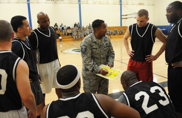 Master Sgt. Kenneth, 48th Intelligence Squadron head coach, provides direction for his team during a timeout in the second half of the Intramural Basketball Championship at the Harris Fitness Center on Beale Air Force Base, Calif., Feb. 22. The 9th Aircraft Maintenance Squadron defeated the 48th IS 37-34. (U.S. Air Force photo by Airman 1st Class Bobby Cummings/Released)