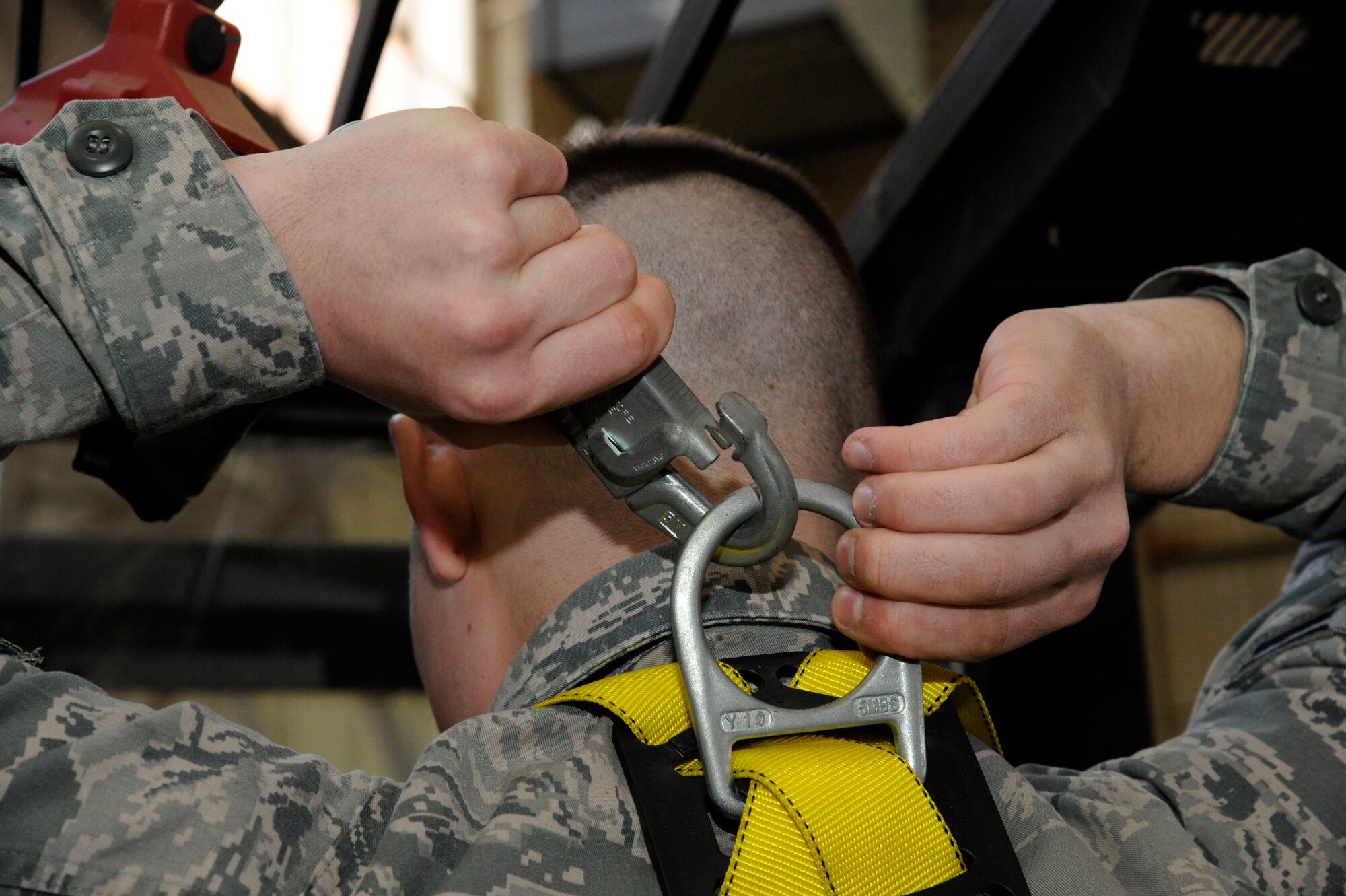Airman 1st Class Frederick Ross, 2nd Logistics Readiness Squadron Aircraft Parts Store, hooks his safety harness to a forklift before moving equipment on Barksdale Air Force Base, La., Feb. 27. The APS serves as the focal point for parts requests, taking requests from other Air Force bases such as Minot Air Force Base, N.D. in need of compatible parts for repairs. (U.S. Air Force photo/Airman 1st Class Andrew Moua)