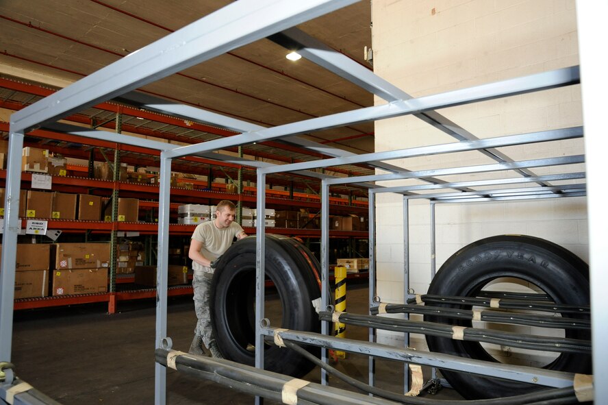 Airman 1st Class Chris Allison, 2nd Logistics Readiness Squadron Aircraft Parts Store, moves a tire into a tire rack on Barksdale Air Force Base, La., Feb. 27. The APS provides a supply point for maintainers who need parts to fix B-52H Stratofortress bombers. The parts range from windows, electronic components, wings and classified material. (U.S. Air Force photo/Airman 1st Class Andrew Moua)