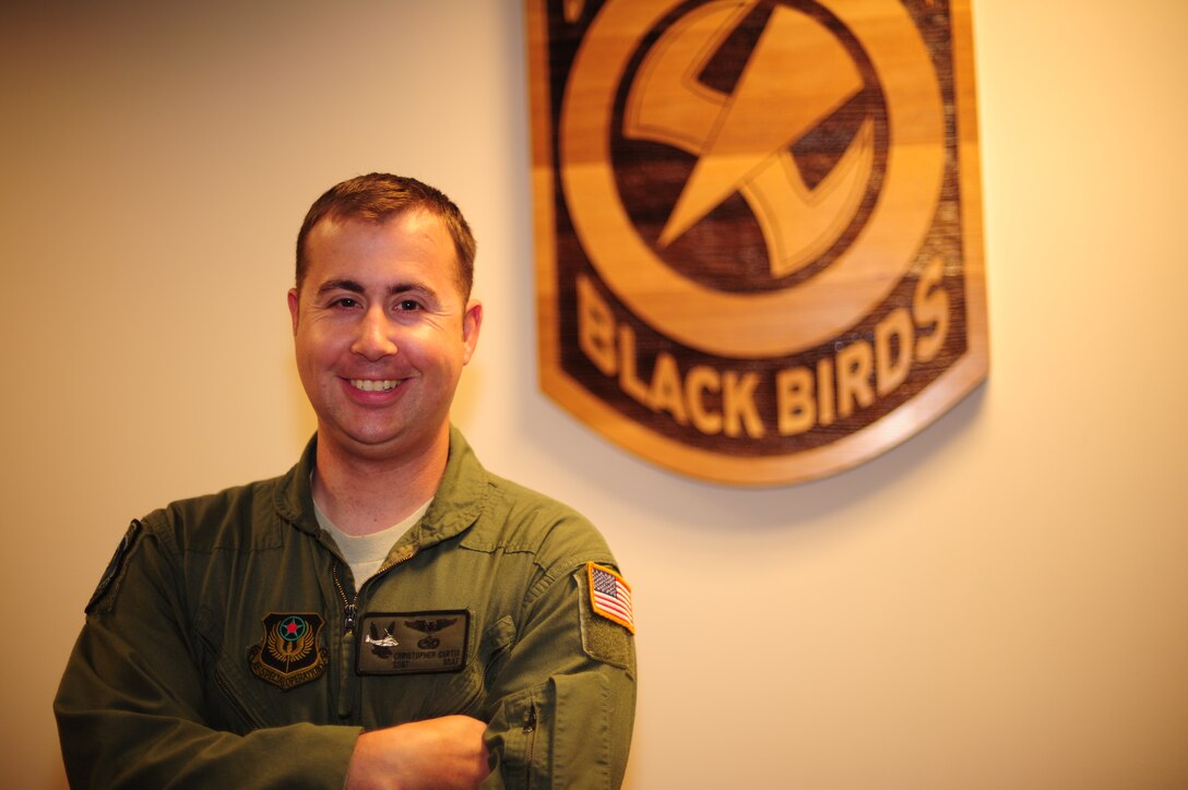 U.S. Air Force Tech. Sgt. Christofer Curtis, a CV-22 flight engineer of the 8th Special Operations Squadron, poses by the squadron logo at Hurlburt Field, Fla., April 6, 2012. Curtis returned to active duty after recovering from injuries sustained during a deployment. (U.S. Air Force photo by Airman 1st Class Gustavo Castillo)