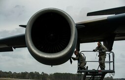 Airman 1st Class Minh Pham and Airman Cory Parks, 437th Aircraft Maintenance Squadron crew chiefs, service the oil on a Globemaster III C-17 aircraft engine during a post-flight inspection Feb. 26, 2013, at Joint Base Charleston - Air Base, S.C. Members of the 437th AMXS inspect, service and maintain C-17A aircraft to enable them to perform assigned global airlift missions ranging from combat support operations and humanitarian relief to aeromedical evacuations. (U.S. Air Force photo/ Senior Airman George Goslin)