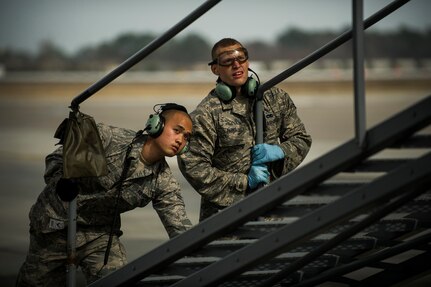 Airman 1st Class Minh Pham and Airman Cory Parks, 437th Aircraft Maintenance Squadron crew chiefs, move a B-1 Stand into position during a post flight inspection Feb. 26, 2013, at Joint Base Charleston - Air Base, S.C. Members of the 437th AMXS inspect, service and maintain C-17A aircraft to enable them to perform assigned global airlift missions ranging from combat support operations and humanitarian relief to aeromedical evacuations. (U.S. Air Force photo/ Senior Airman George Goslin)