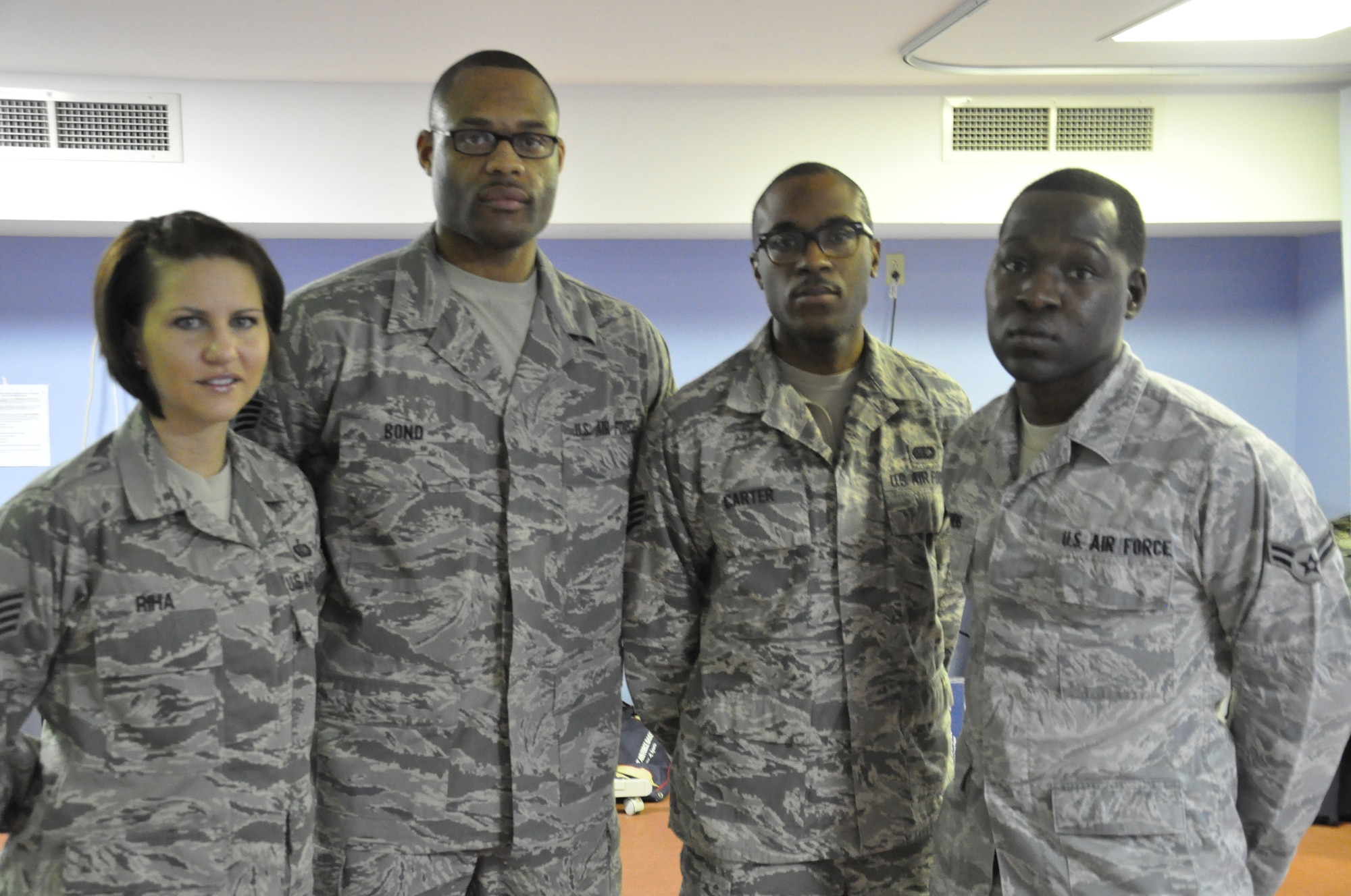 Staff Sgt. Jessica Riha, Staff Sgt. Marquis Bond, Staff Sgt. Ahkiem Carter and Airman 1st Class Coati Owens were a part of the Fitness Assessment Cell team that saved an Airman's life.  The team was never told what caused the airman to stop breathing, but they were told that she made a full recovery. (U.S. Air Force photo/Airman 1st Class Jake Eckhardt)