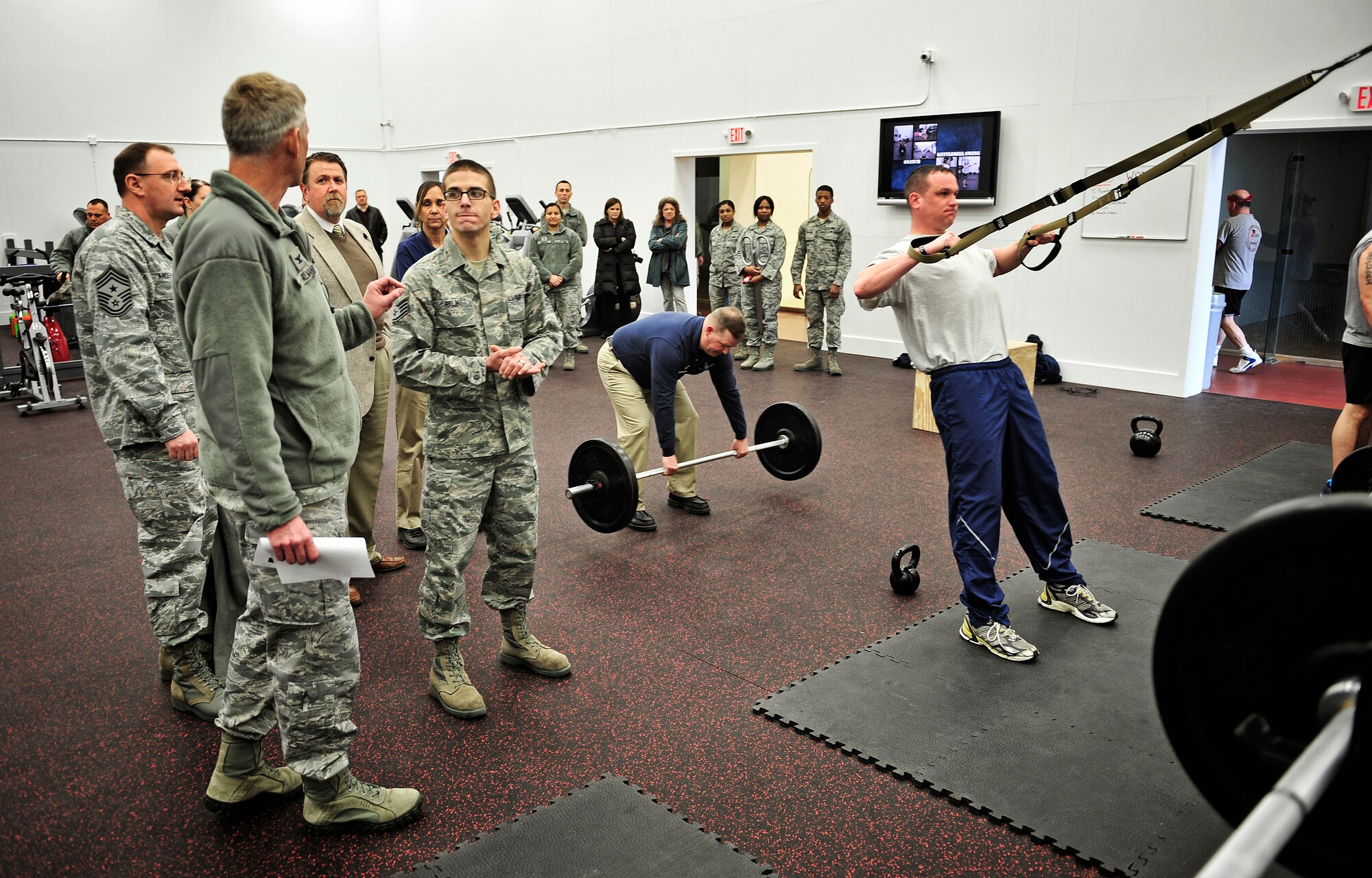 Staff Sgt. Jason Relik, 375th Force Support Squadron, explains a new piece of workout equipment to Col. David Almand, 375th Air Mobility Wing commander, during a tour of the new high intensity training room Feb. 20. The James Sports Center recently completed construction on the new room geared toward a high intensity workout that patrons were unable to perform previously. The room also has a contained children's play area with playground equipment, children's cardio machines and an entertainment center.  (U.S. Air Force photo/ Staff Sgt. Ryan Crane)