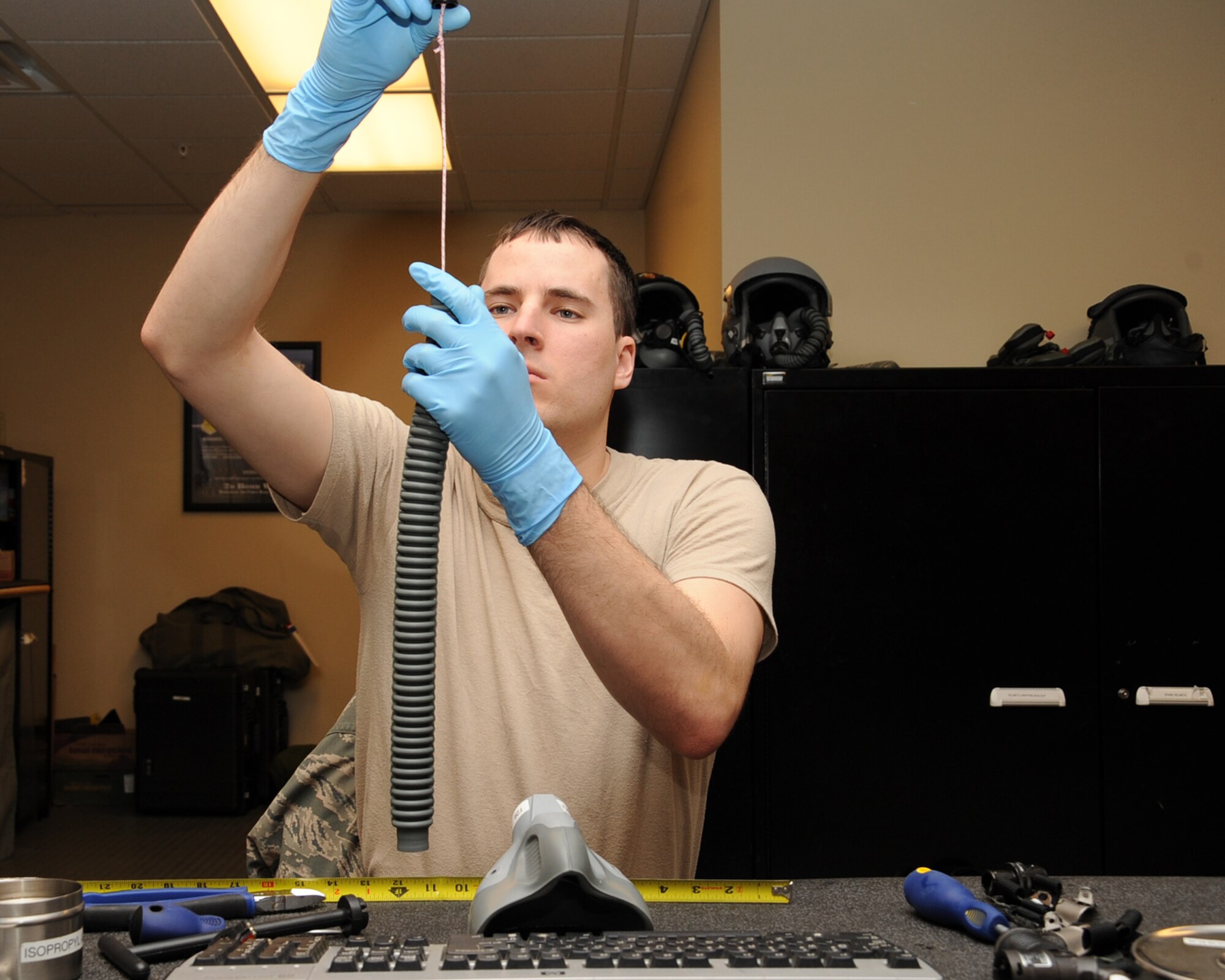 Airman 1st Class Jason Konrad, 2nd Operation Support Squadron Aircrew Flight Equipment apprentice, fixes the breathing hose on an NBU-12P mask on Barksdale Air Force Base, La., Feb. 27. The mask is used to assist aircrew in breathing during take-offs and landings. (U.S. Air Force photo/Senior Airman Sean Martin)
