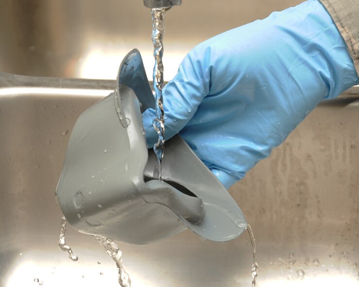 Senior Airman Nicalayae Buford, 2nd Operation Support Squadron Aircrew Flight Equipment journeyman, cleans the nose piece to an NBU-12P mask on Barksdale Air Force Base, La., Feb. 27. The masks are cleaned and checked for defects every 30 days to ensure they are serviceable for aircrew. (U.S. Air Force photo/Senior Airman Sean Martin)