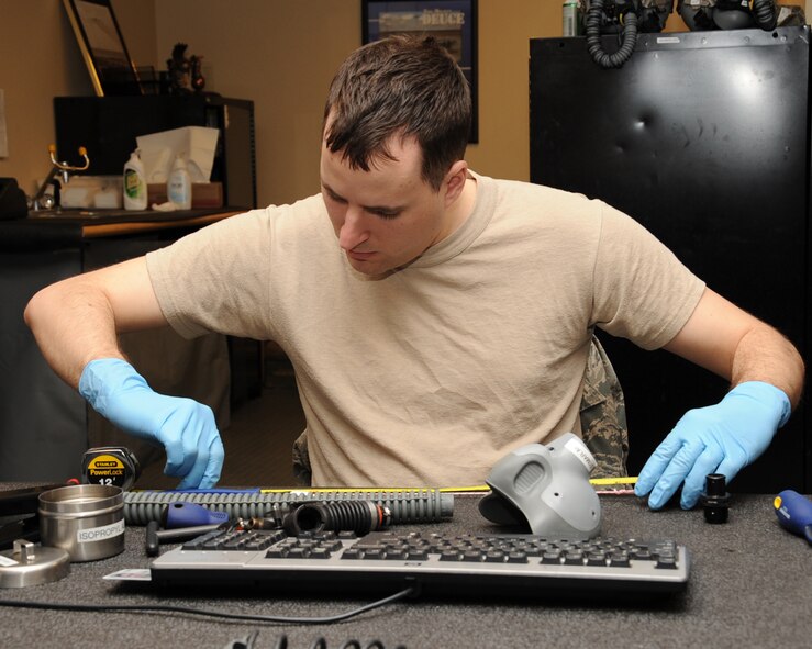 Airman 1st Class Jason Konrad, 2nd Operation Support Squadron Aircrew Flight Equipment apprentice, works on an NBU-12P mask on Barksdale Air Force Base, La., Feb. 27. The AFE shop provides aircrew with life-saving equipment in the event of a crash including helmets, oxygen masks, survival vests, anti-exposure suits, life preservers and night vision goggles. (U.S. Air Force photo/Senior Airman Sean Martin)