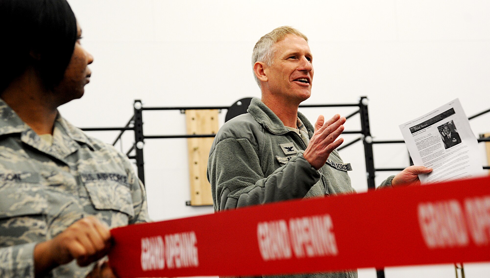 Col. David Almand, 375th Air Mobility Wing commander, says a few words about fitness prior to the ribbon cutting on the new high intensity training room Feb. 20. The James Sports Center recently completed construction on the new room geared toward a high intensity workout that patrons were unable to perform previously. The room also has a contained children's play area with playground equipment, children's cardio machines and an entertainment center.  (U.S. Air Force photo/ Senior Airman Tristan English)