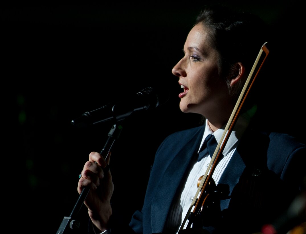 Tech Sgt. Emily Wellington, a U.S. Air Force Band singer and fiddle player for the Celtic Aire ensemble, sings during the Guest Artist Series concert at the Daughters of the American Revolution Constitution Hall in Washington D.C., Feb. 24, 2013. The Rouges, a Celtic rock band, performed as the guest artists. (U.S. Air Force photo/ Staff Sgt. Perry Aston)