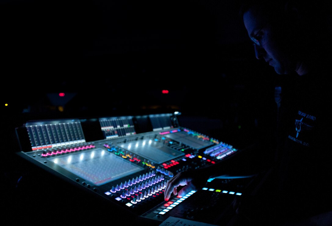 Master Sgt. Adam Dempsey, a U.S. Air Force Band technical support specialist, works the sound board during the Guest Artist Series concert at the Daughters of the American Revolution Constitution Hall in Washington D.C., Feb. 24, 2013. The Rouges, a Celtic rock band, performed as the guest artists. (U.S. Air Force photo/ Staff Sgt. Perry Aston)(Released)