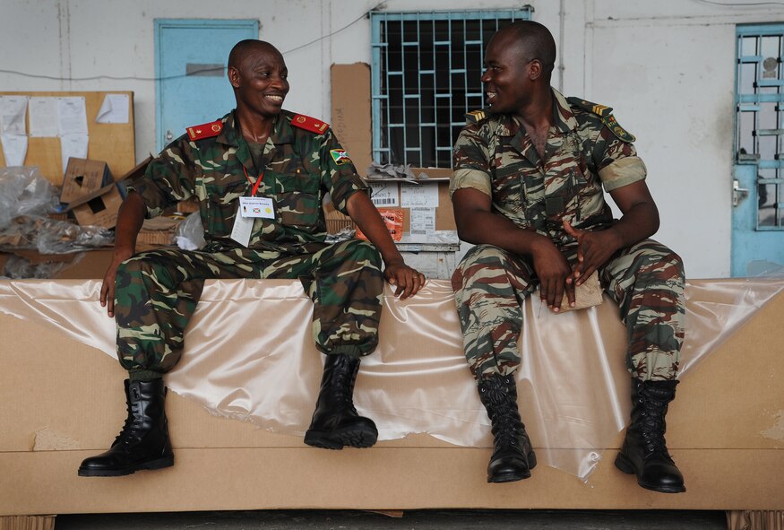 DOUALA, CAMEROON – African partner nation members share a quiet moment after building low cost low altitude bundles with U.S. Army parachute riggers assigned to the 5th Quartermaster Battalion Detachment, Kaiserslautern, Germany, at Douala Air Force Base, Douala, Cameroon, Feb. 21, 2013. Central Accord 2013 is a joint exercise in which U.S., Cameroon and neighboring Central African militaries partner to promote regional cooperation while and increasing aerial resupply and medical readiness capacity. (Photo by Master Sgt. Stan Parker, 621st CRW Public Affairs)