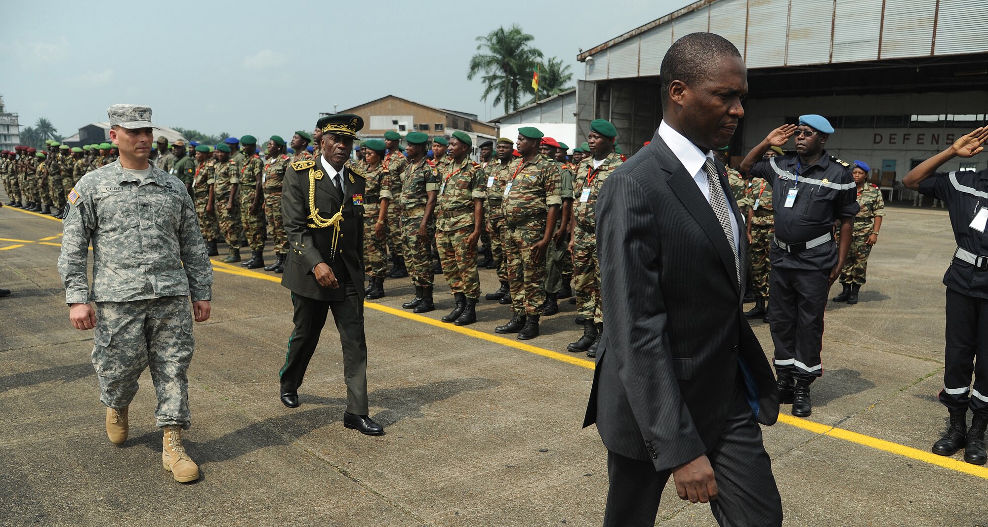 DOUALA, CAMEROON –  U.S. Army Brig. Gen. Peter Corey, U.S. Army Africa deputy commanding general and senior U.S. Army exercise official, is led by Joseph Beti Assomo, governor of the Littoral Region, as they conduct a pass in review exercise of participants during the opening ceremony for Central Accord 13, at Douala Air Force Base, Douala, Cameroon, Feb. 20, 2013. Central Accord 2013 is a joint exercise in which U.S., Cameroon and neighboring Central African militaries partner to promote regional cooperation while and increasing aerial resupply and medical readiness capacity. (Photo by Master Sgt. MSgt Stan Parker, 621st CRW Public Affairs)